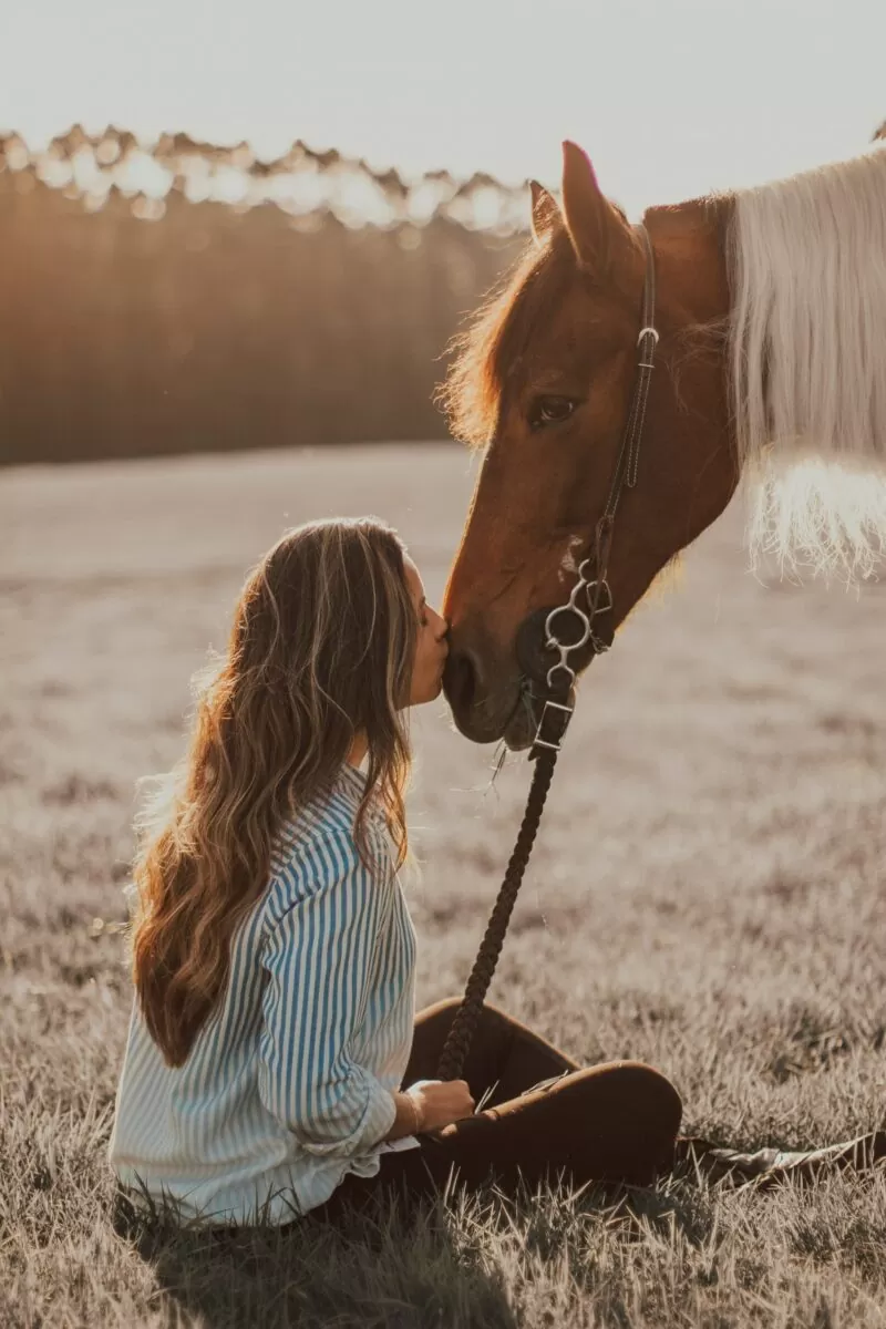 Woman kissing a horse